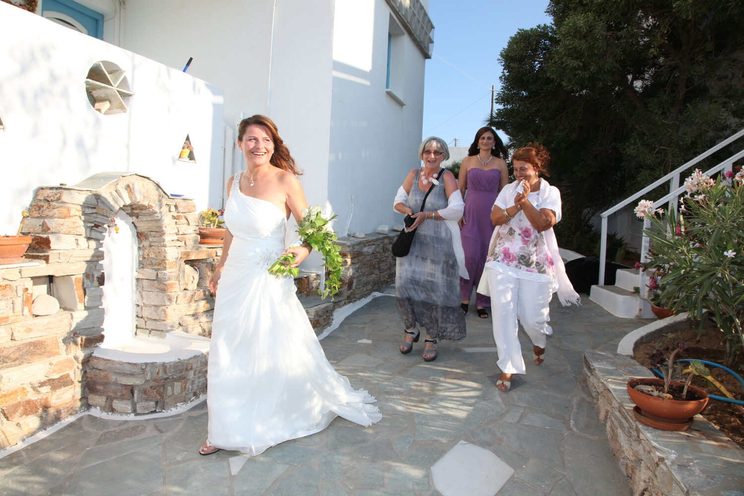 The bride riding the donkey through the village