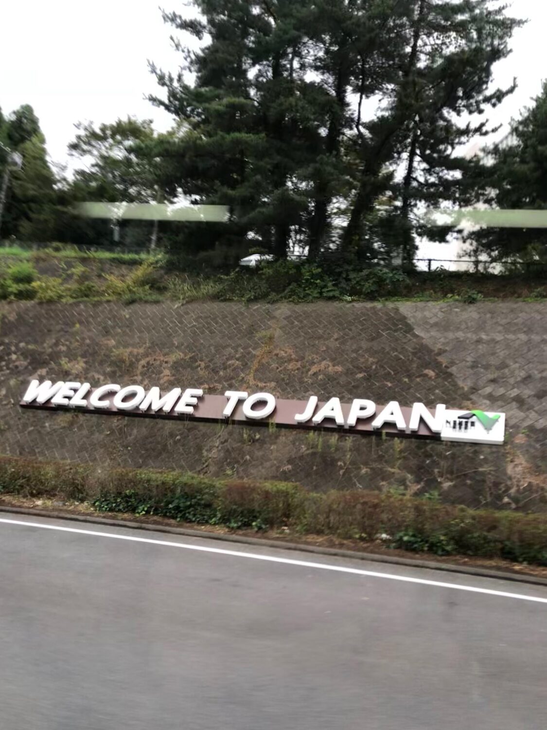 A Welcome to Japan sign beside the road