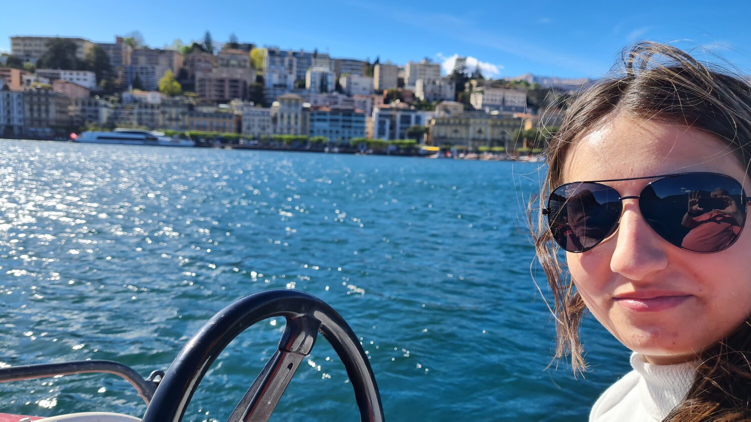 Maritza at the wheel of a boat