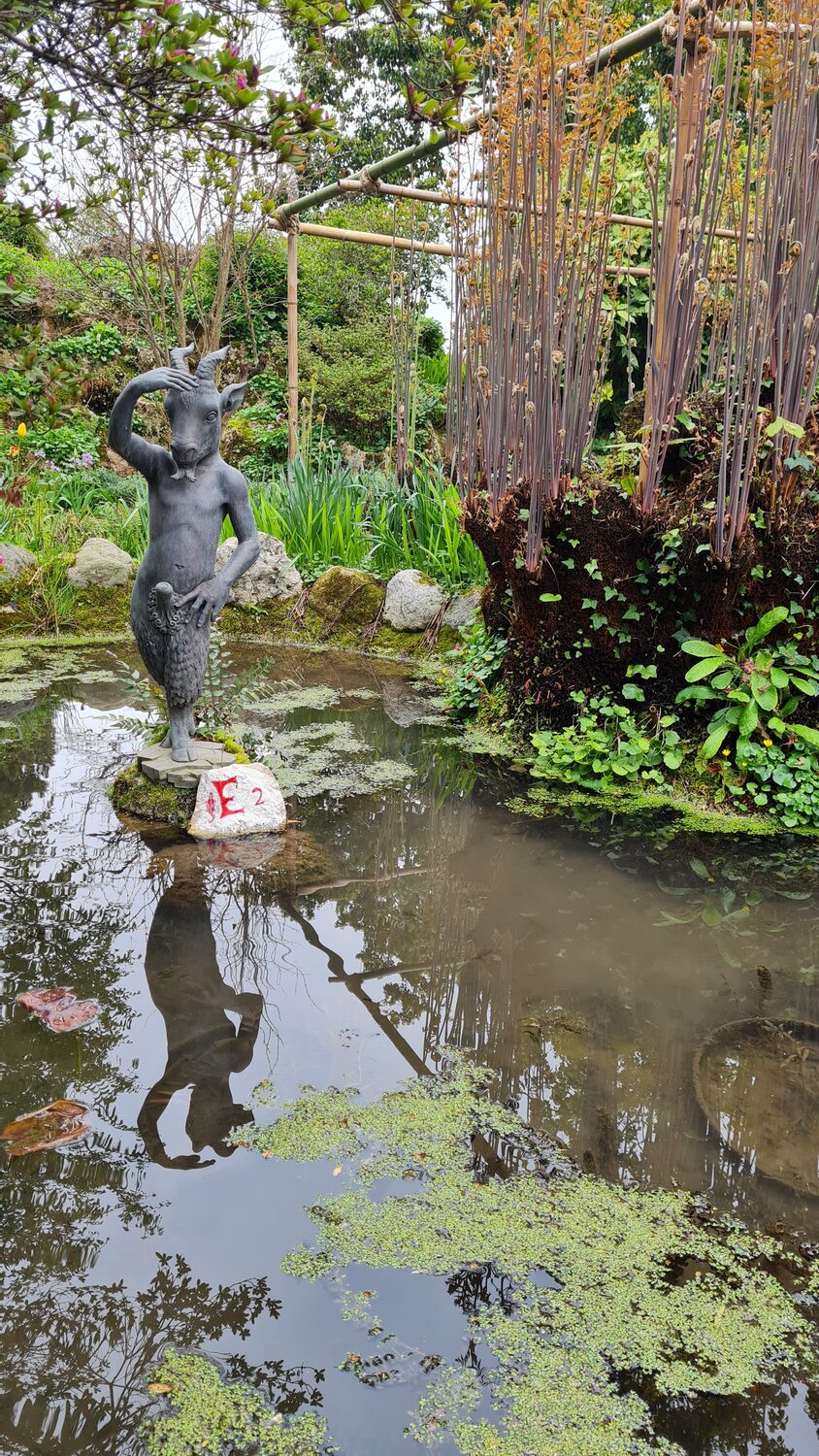A pond and statue in the botanical garden