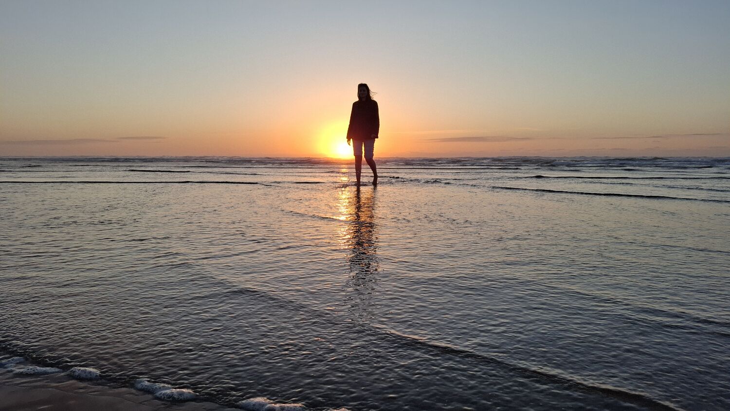 A figure on the mirrored sand