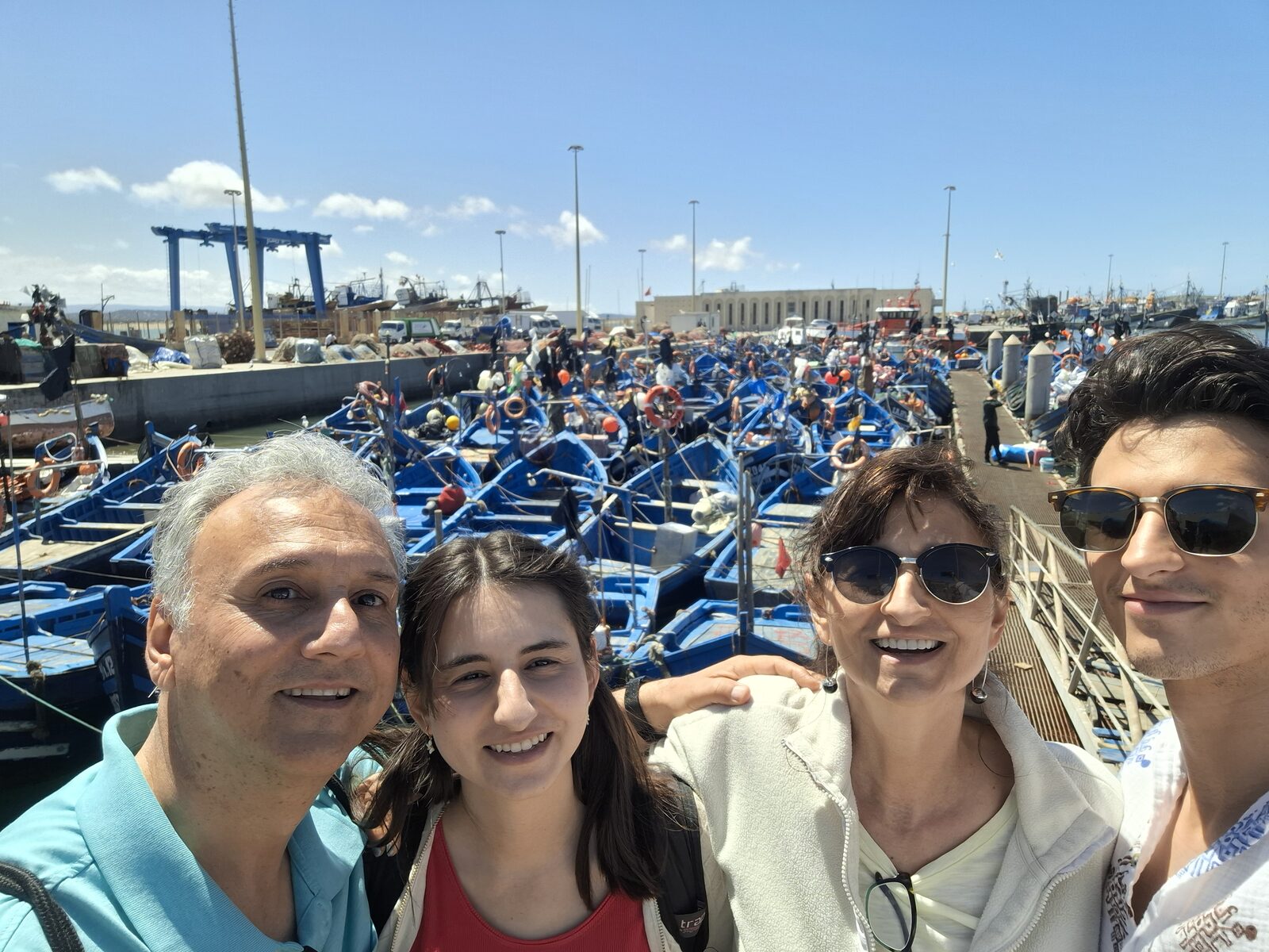 The family among the blue boats