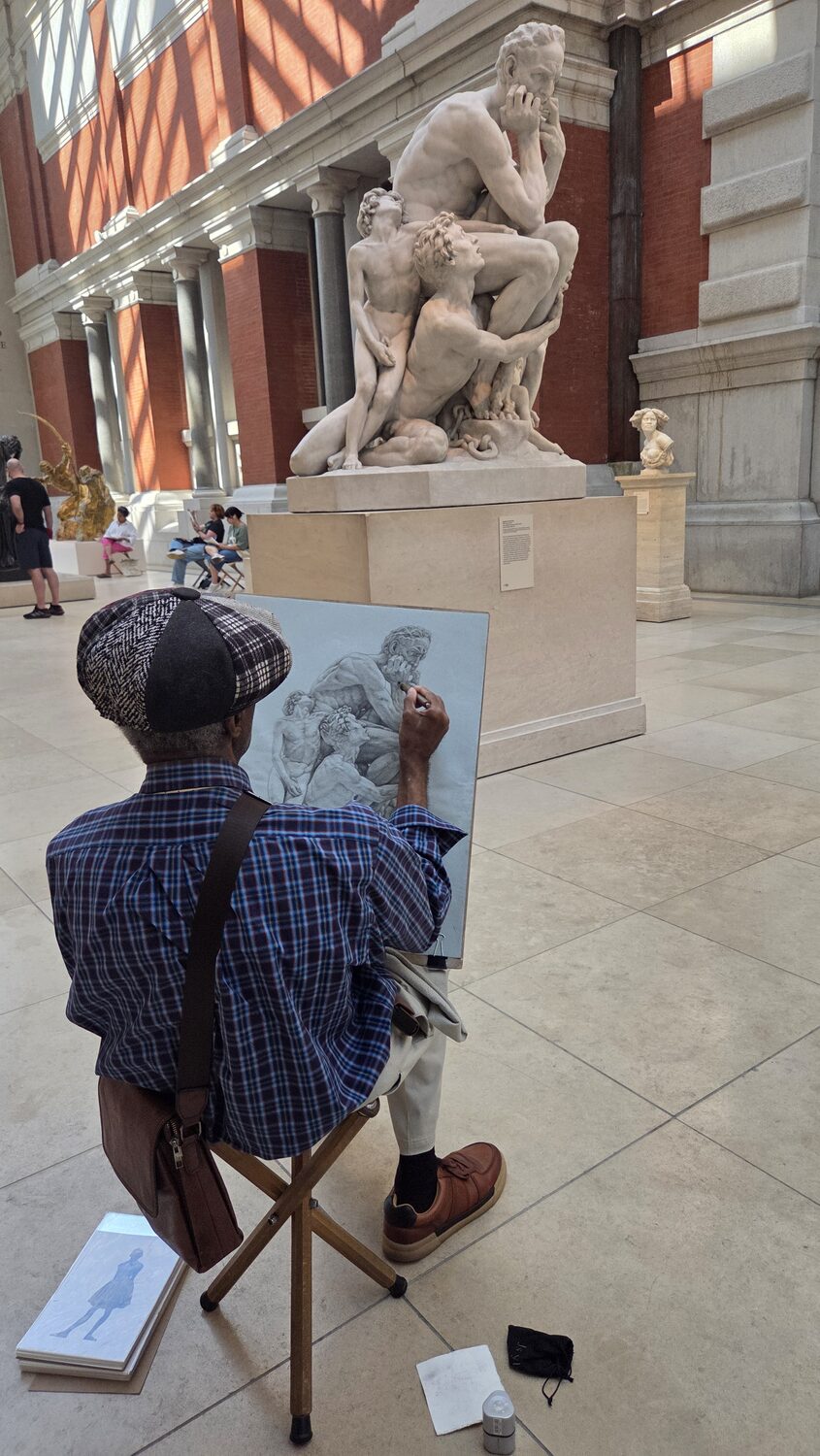 An artist sketching a sculpture at the Met