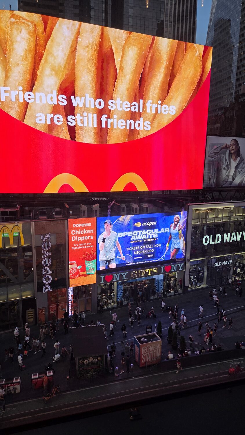 A billboard reading friends who steal fries are still friends